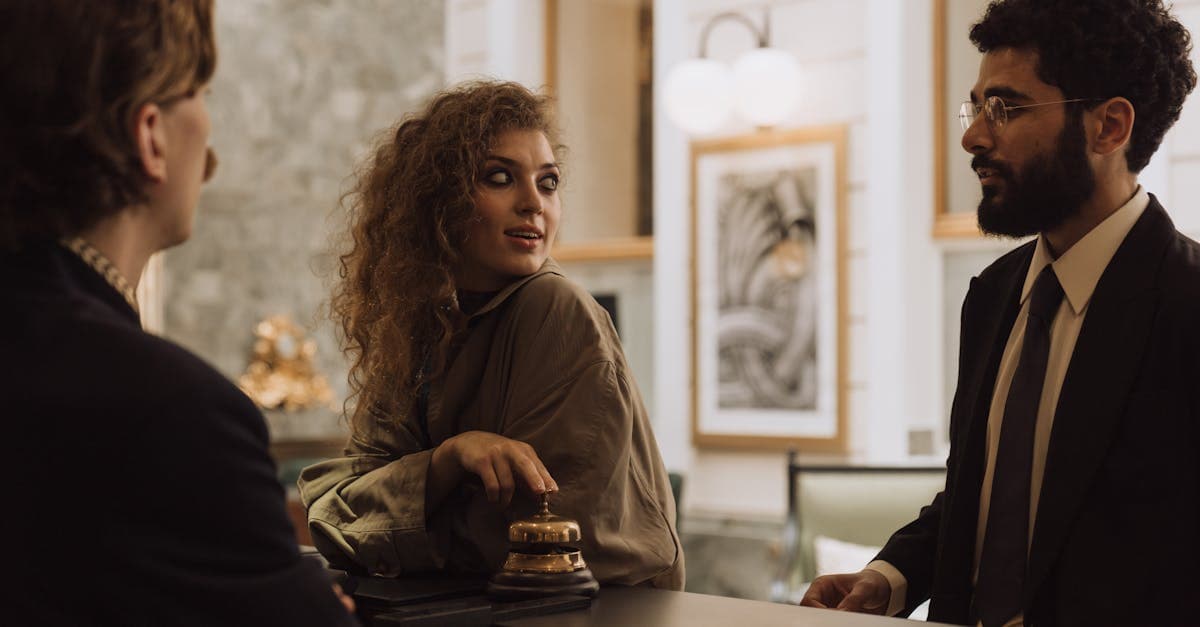 Guests interacting at a luxurious hotel reception desk, emphasizing hospitality and service.