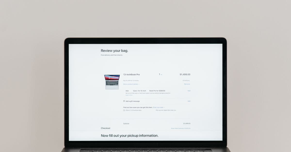 Minimalist laptop showing an online checkout screen on a white background, ideal for tech context.