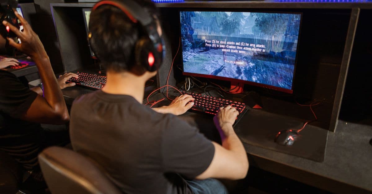 Two gamers immersed in a video game with high-tech equipment and vibrant gaming setup.