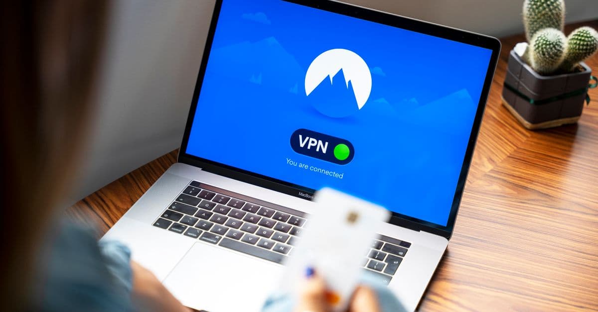 A person using a VPN on a laptop, symbolizing secure internet browsing in a modern indoor setting.