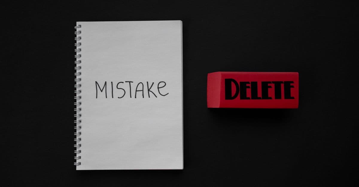 Notebook labeled 'Mistake' next to a red delete eraser on a dark background.