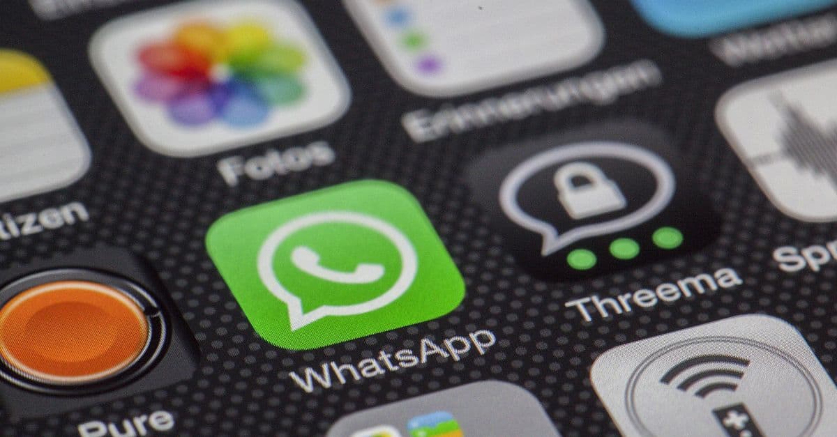 Detailed macro of smartphone screen showcasing popular app icons like WhatsApp.