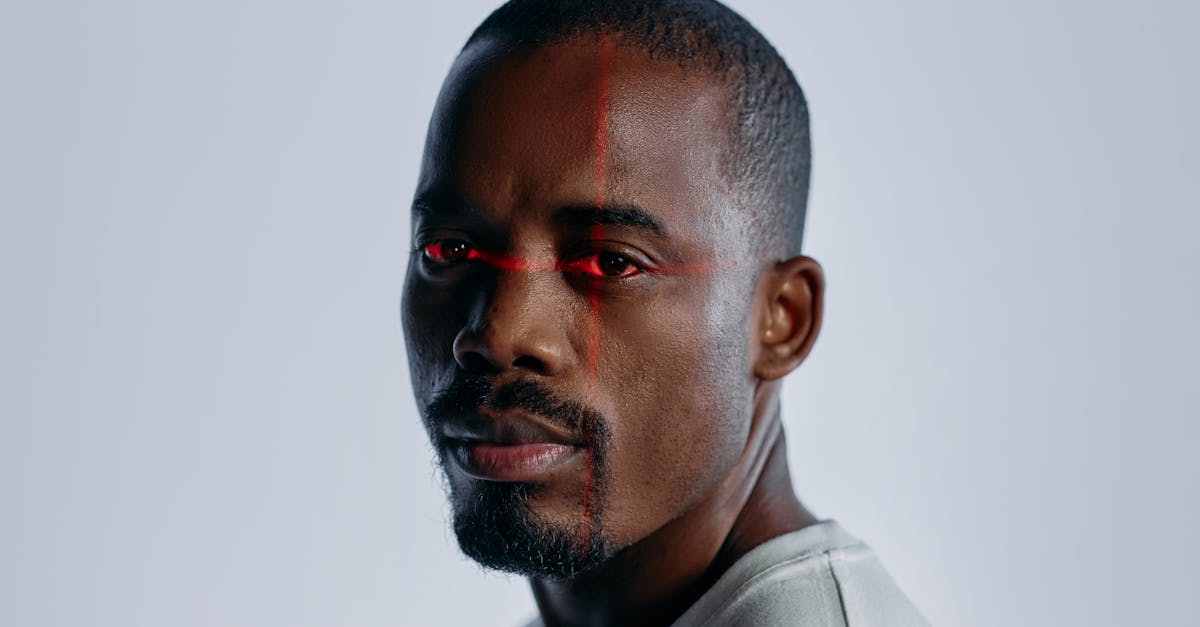 Close-up of a man with a futuristic laser scanning effect over his eyes, suggesting technology and identity themes.