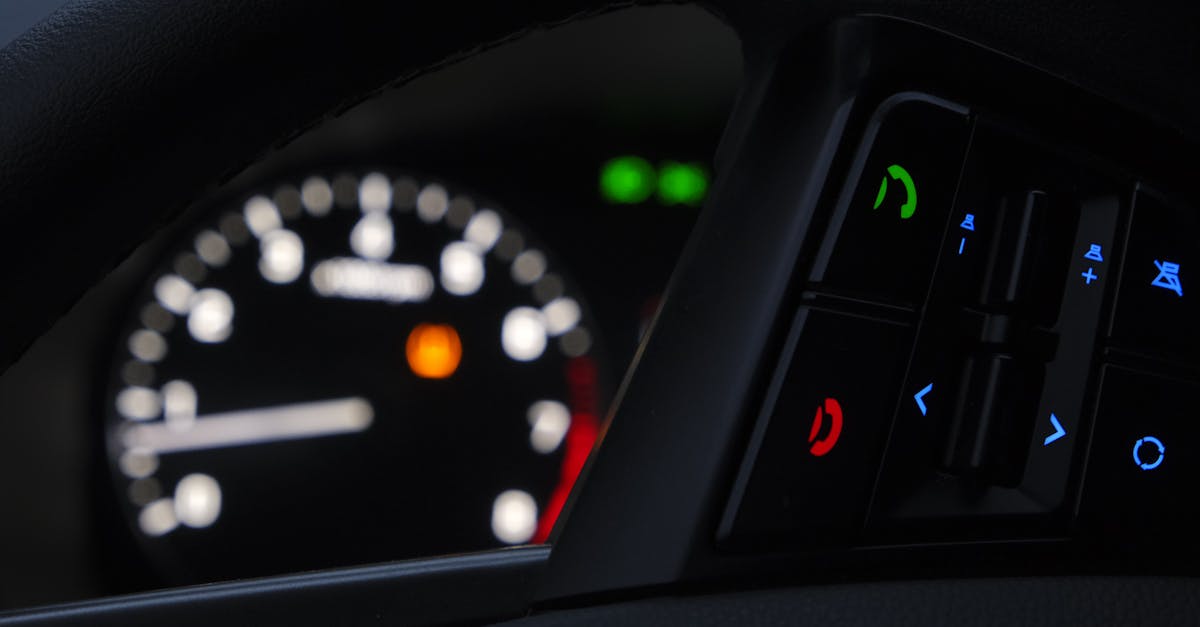 Close-up of a modern car dashboard displaying illuminated controls and gauges.