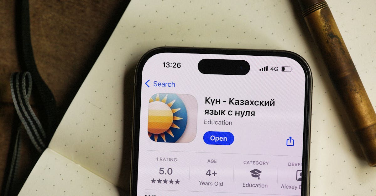 Smartphone displaying a Kazakh language learning app in a cozy setting.