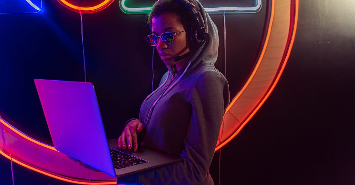 Woman with headset using a laptop against a neon backdrop, showcasing digital privacy.