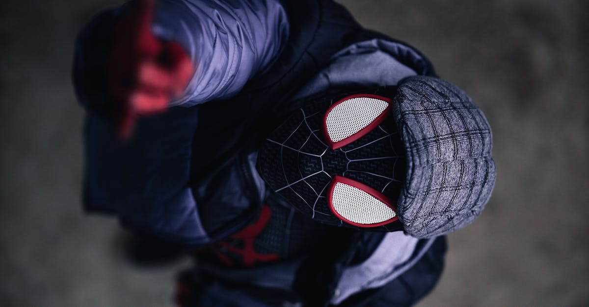 Aerial view of person cosplaying Spider-Man character in detailed costume outdoors.
