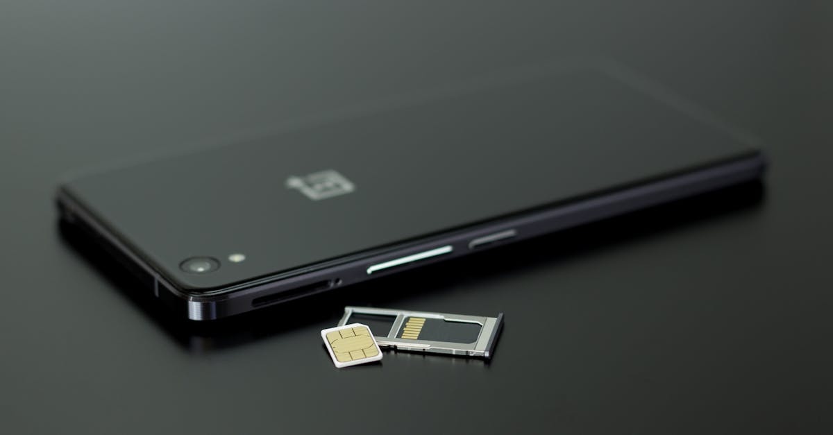 Close-up of a smartphone with a SIM card and memory card, showcasing modern technology.