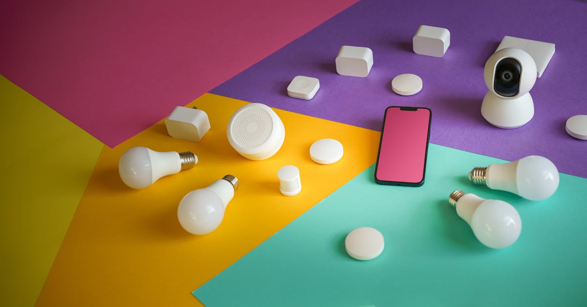 A vibrant display of smart home devices including bulbs, sensors, and a smartphone on a colorful background.