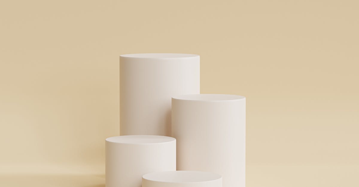 Elegant beige cylindrical podiums for a sleek and minimal design presentation.