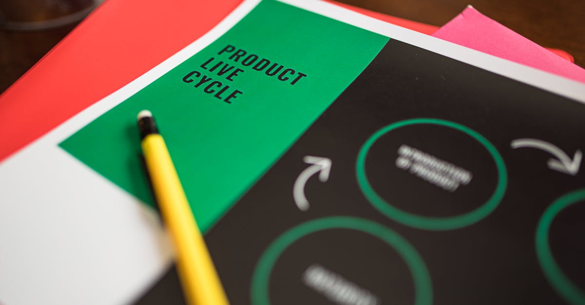 Close-up of a product life cycle diagram with colorful papers and a pencil.