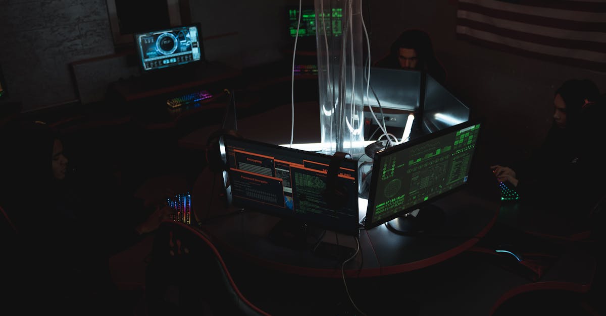 Team of cybersecurity experts collaboratively working on data protection in a dimly lit room filled with computers.