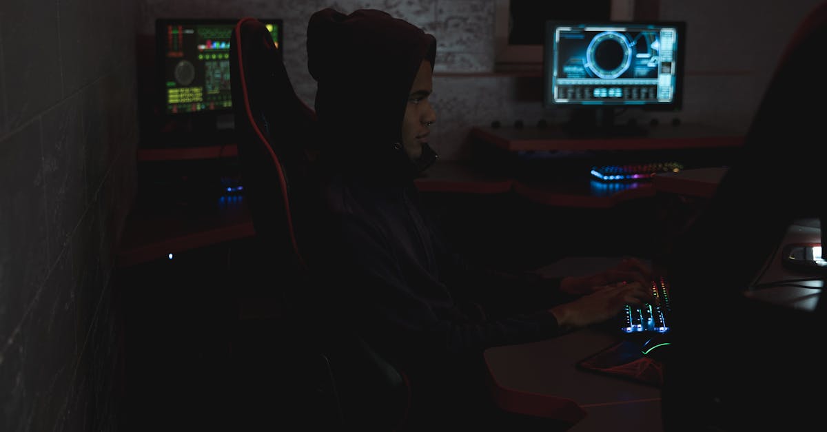 A professional analyzing data on multiple monitors in a dark room, highlighting cybersecurity themes.