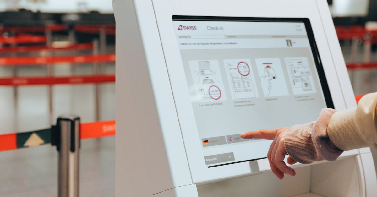 Passenger using self-service check-in kiosk at airport for convenient travel experience.