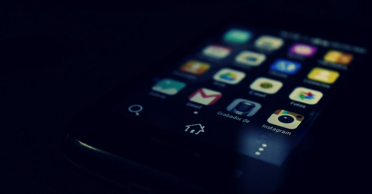 Dark-themed close-up of a smartphone screen highlighting various apps and touchscreen technology.
