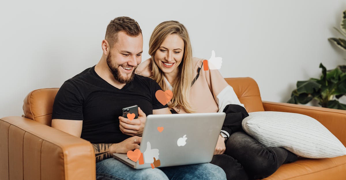 A couple sitting on a sofa, smiling while on a video call with heart and thumbs-up icons.