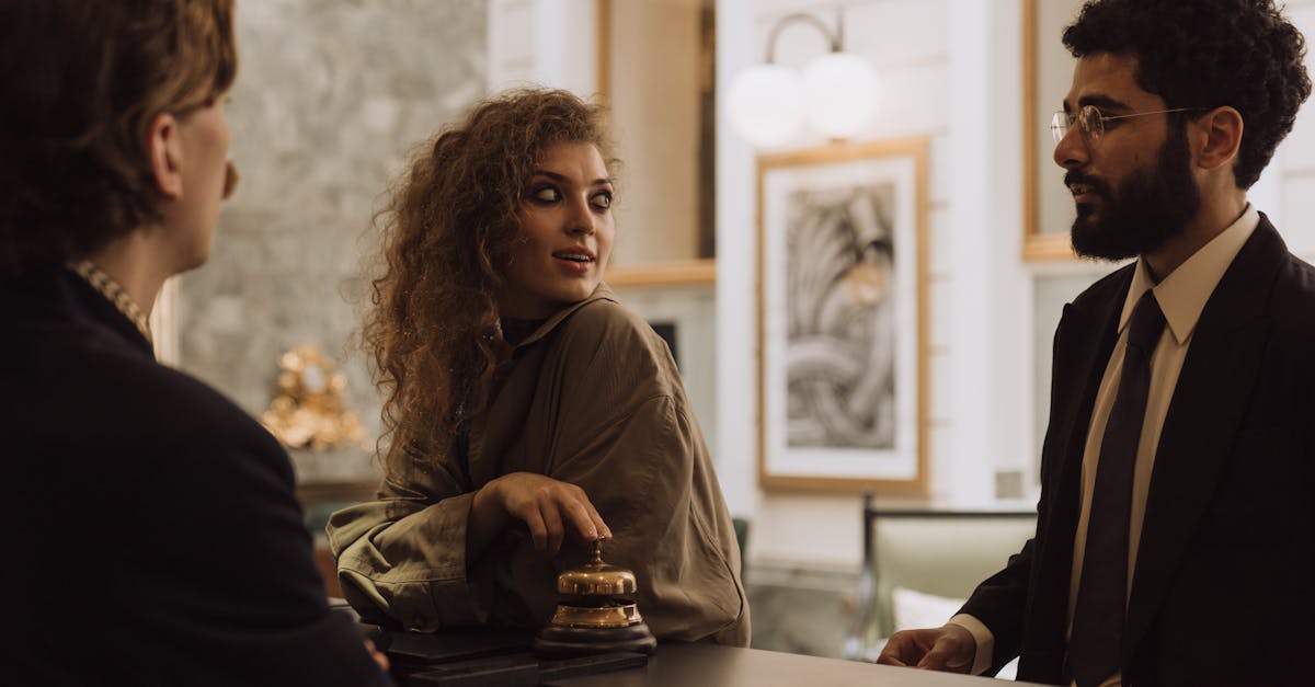 Guests interacting at a luxurious hotel reception desk, emphasizing hospitality and service.