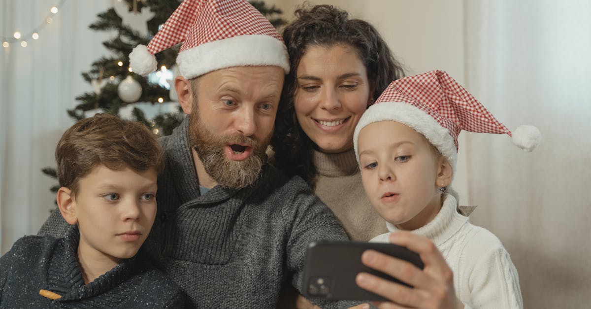 Joyful family wearing Santa hats making a video call at Christmas time, capturing festive togetherness.