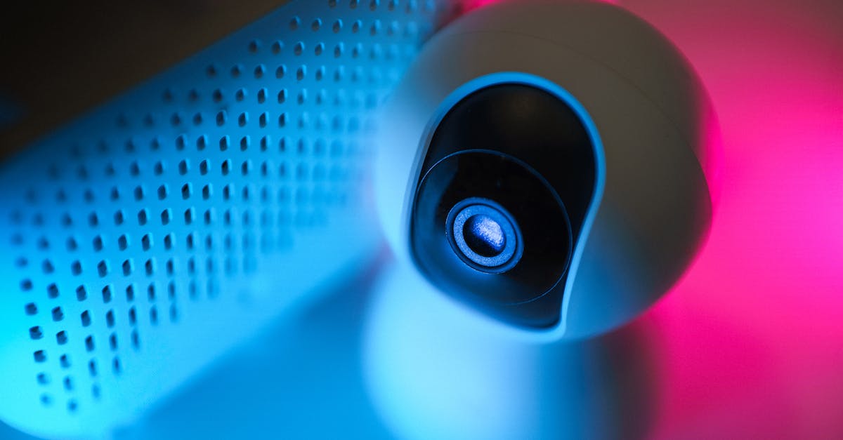 Close-up of a surveillance camera with neon lighting, symbolizing modern home security technology.