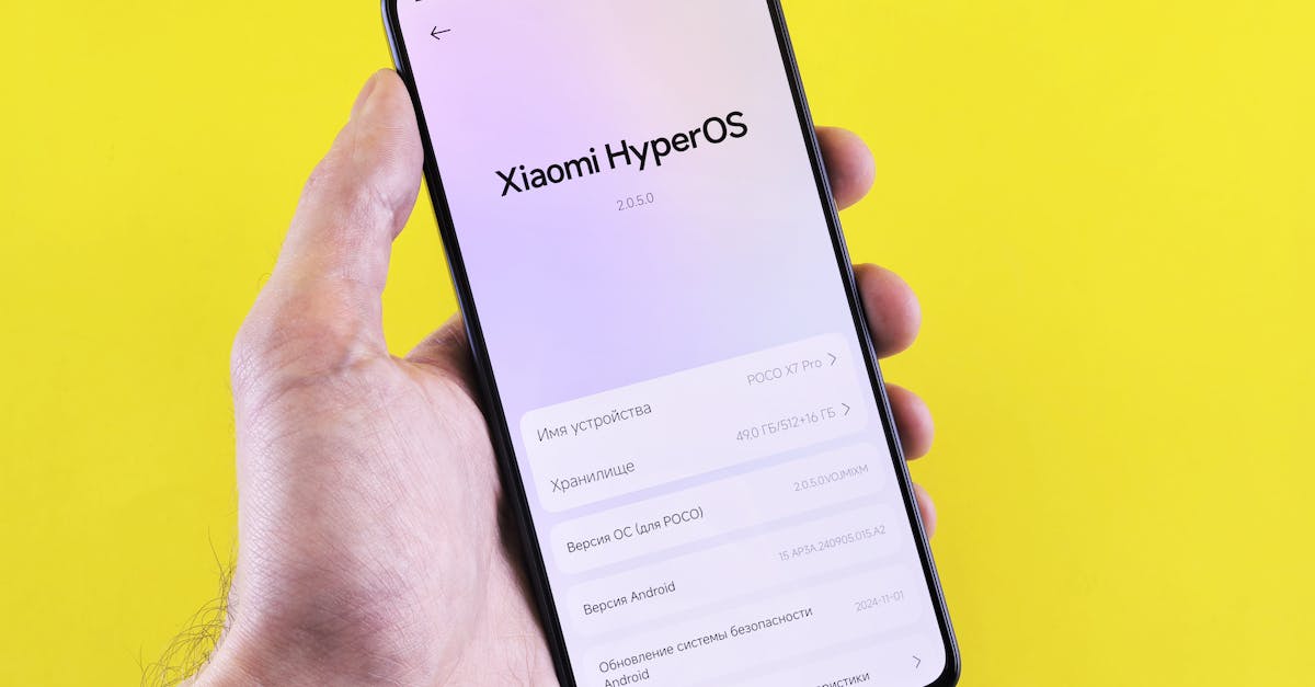 Close-up of a smartphone displaying Xiaomi HyperOS interface, held by a hand against a bright yellow background.