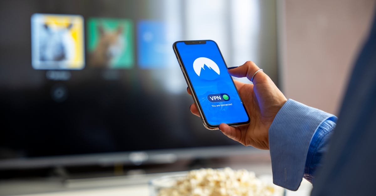 Person using VPN on smartphone while watching smart TV at home.