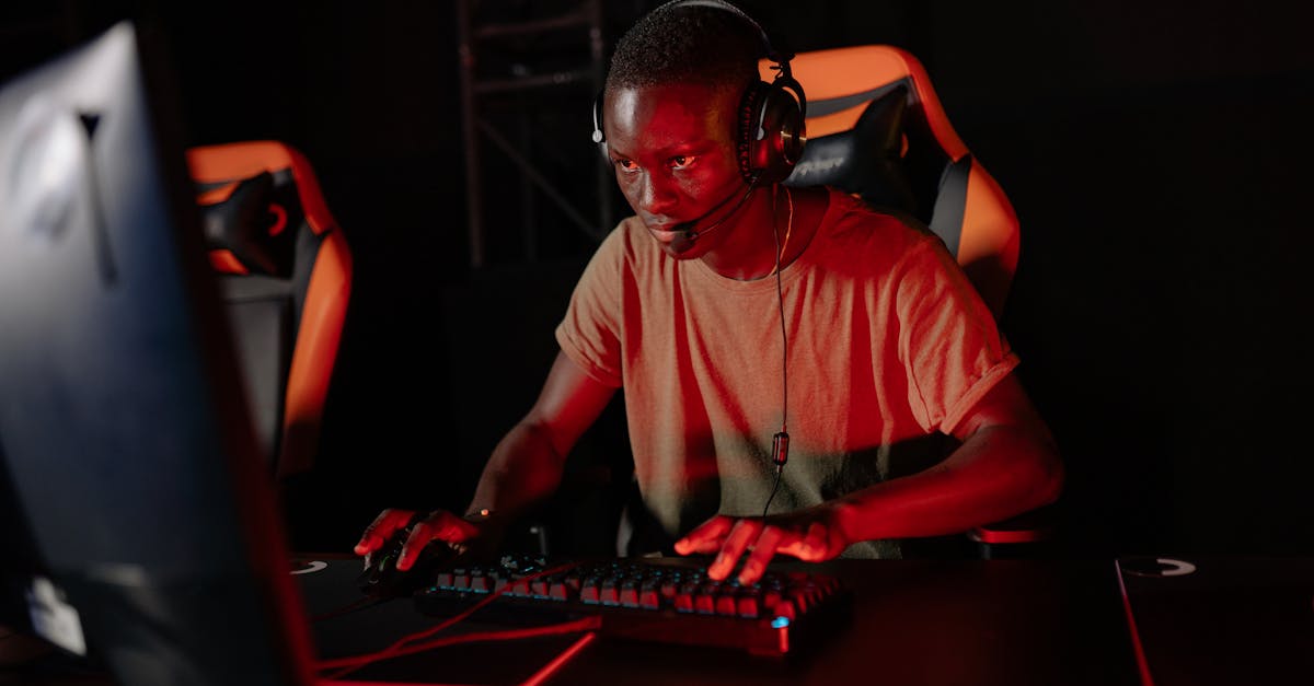 Focused gamer playing online with headset and red lighting environment.