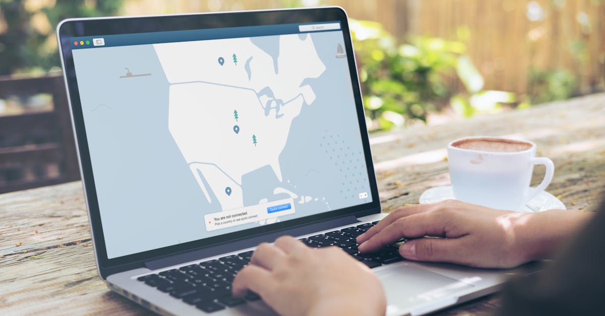 Hands typing on a laptop outdoors with a VPN interface displayed, next to a cup of coffee.