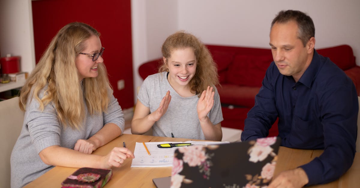 A family happily engaged in remote learning at home using a laptop. Educational collaboration.
