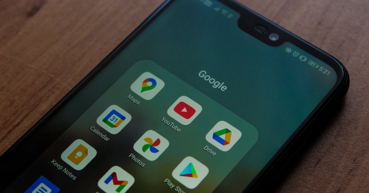 Close-up of a smartphone showing various Google apps on its screen.