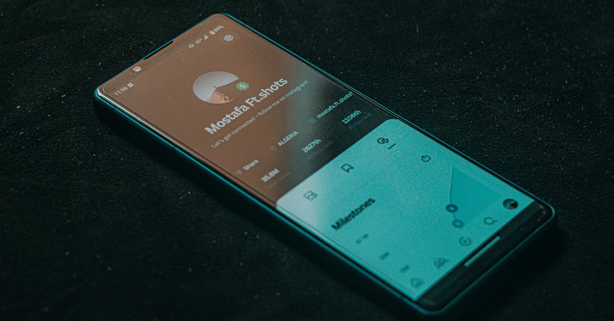 A smartphone displaying an app screen lies on a dark surface, highlighting technology.